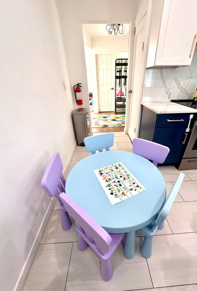 Light blue children's table with lavender chairs in the activity nook