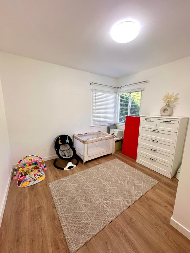 Quiet rest room with a crib, baby swing, and white dresser
